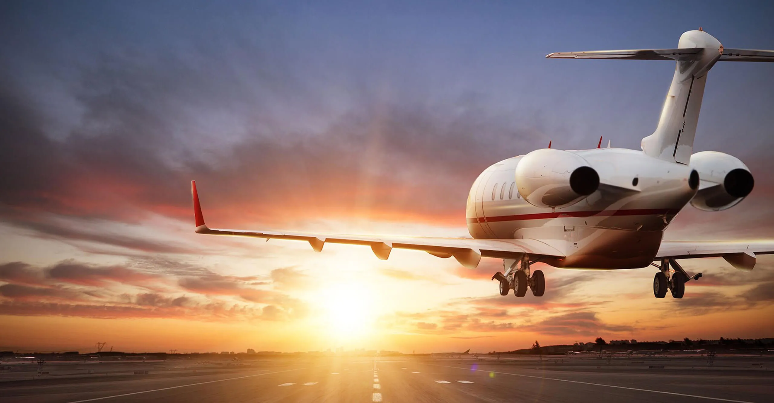 Private jet flying at sunset
